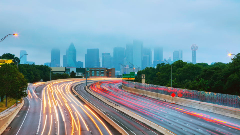Dallas,Texas, silhouettes of cityscapes and stripes of light indicating road traffic.