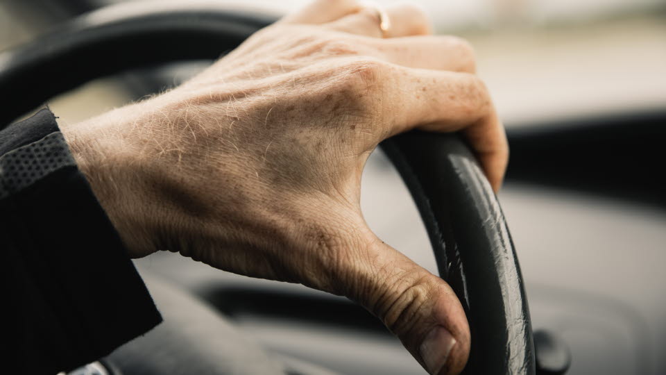 Hand on steering wheel